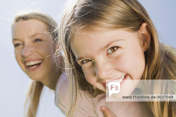 Germany  Bavaria  Munich  Mother and daughter (6-7) smiling  close-up