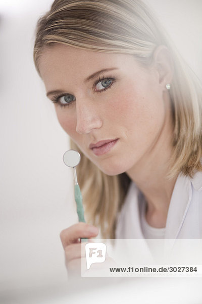 Germany  Bavaria  Landsberg  Female Dental assistant holding mirror  portrait