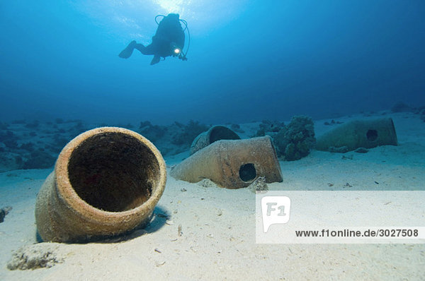 Egypt  Red Sea  Scuba diver and amphoras on ocean bed