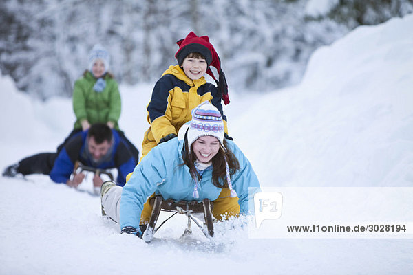 Germany  Bavaria  Family sledding  having fun