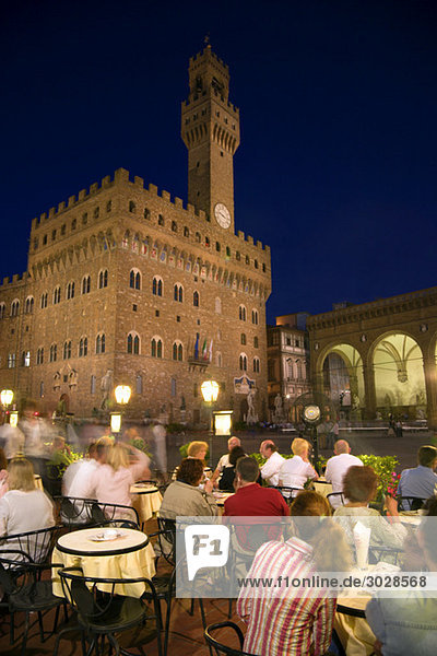 Italy  Tuscany  Florence  Palazzo Vecchio at night  sidewalk cafe in foreground