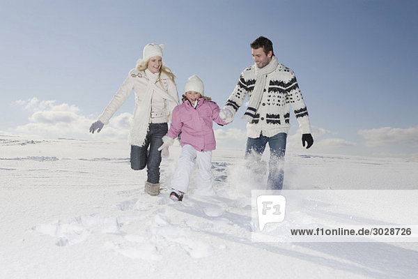 Germany  Bavaria  Munich  Family with daughter (6-7) in snowy landscape