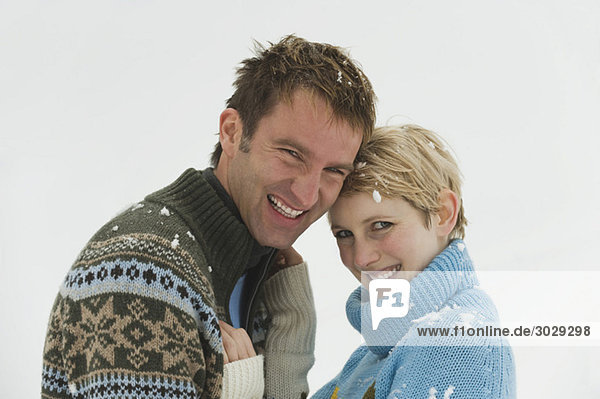 Young couple in winter clothes  head-to-head  portrait