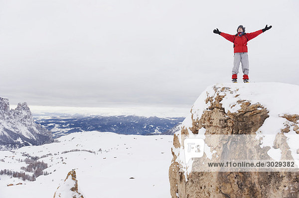 Italy  South Tyrol  Woman in winter clothes on mountain top  cheering