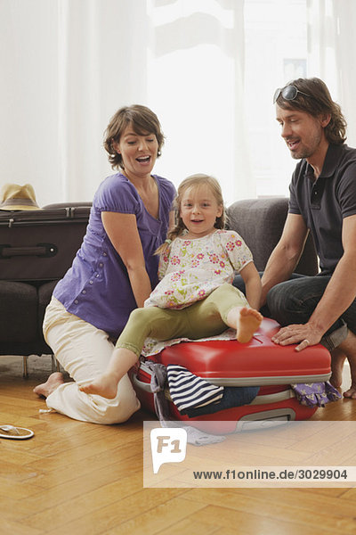 Germany  Leipzig  Family packing suitcase