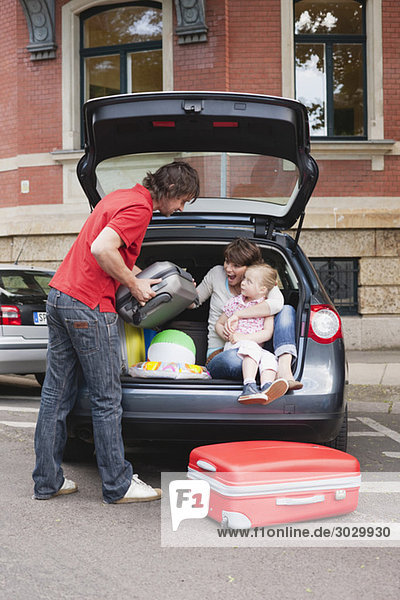 Germany,  Leipzig,  Family loading luggage into car