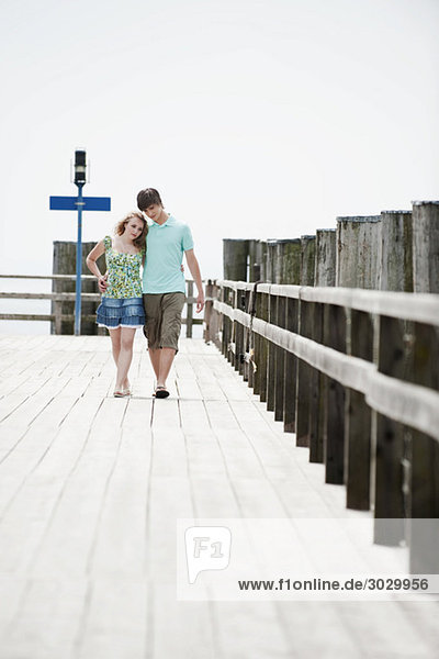 Germany  Bavaria  Ammersee  Couple walking across pier