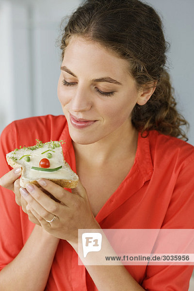 Close-up of a woman eating sandwich