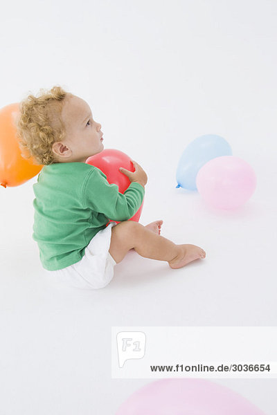 Baby boy playing with a balloon