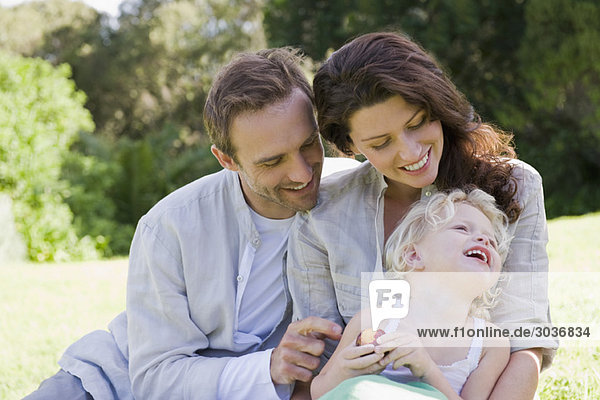 Family smiling in a lawn
