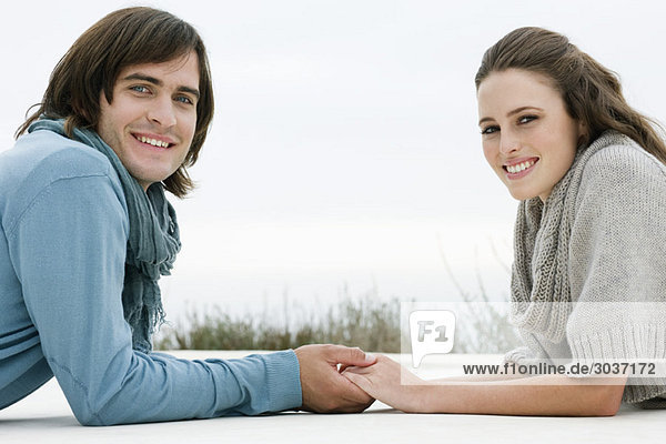 Couple holding hands of each other and smiling