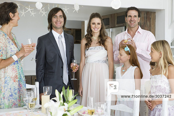 Newlywed couple enjoying with guests in a party