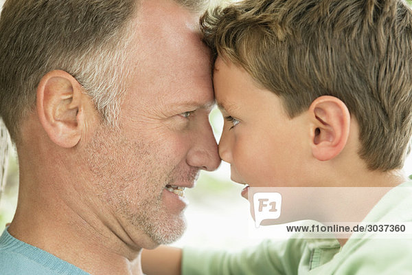 Man and his son rubbing noses