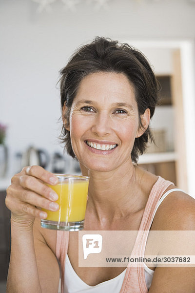 Portrait of a woman holding a glass of juice