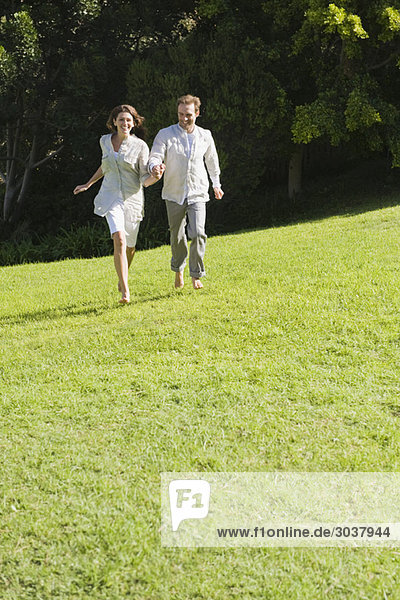 Couple running on grass