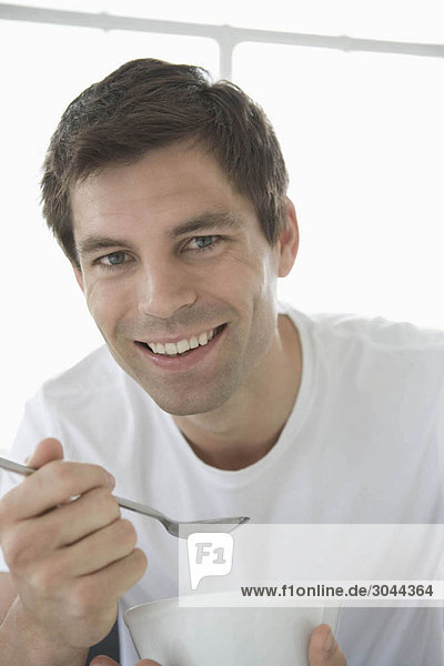 Portrait of a man holding a bowl.