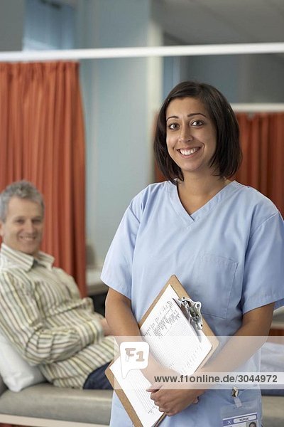 Lächelnde Krankenschwester  Patientin dahinter