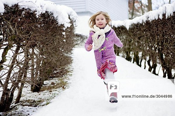 Scandinavian girl running in snow