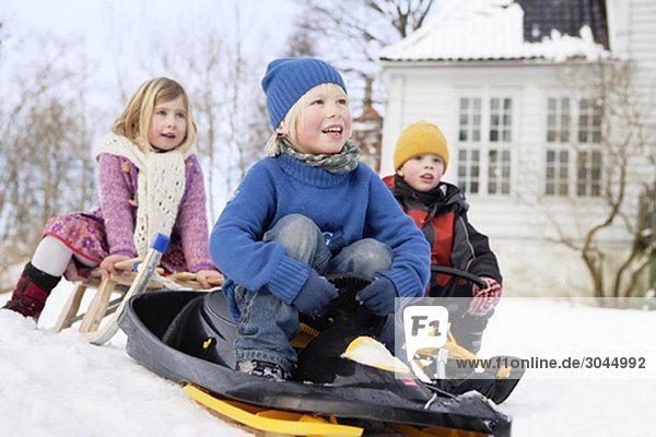 Scandinavian children on sleds