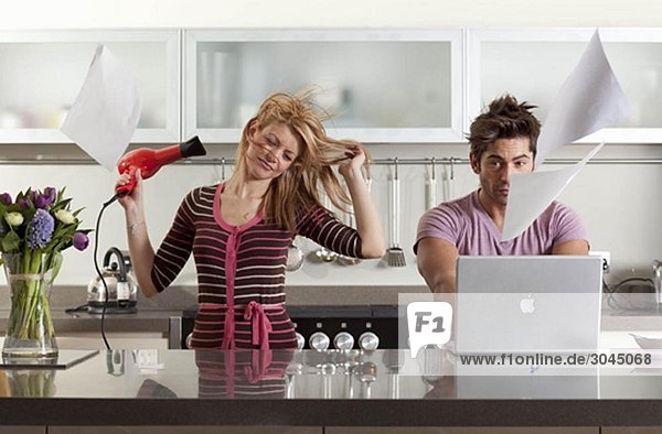 woman drying hair next to partner