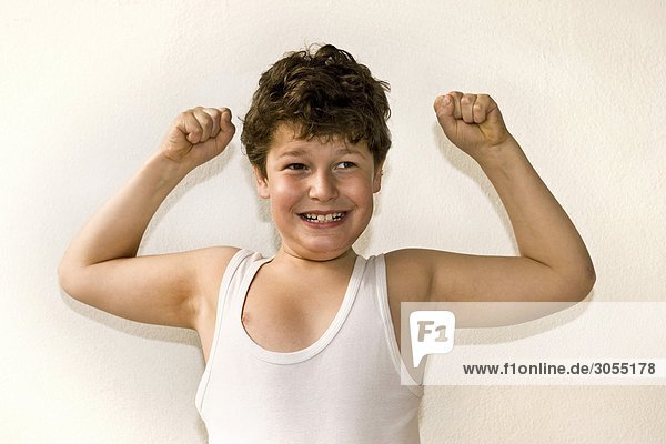 Boy showing his muscles like a strongman