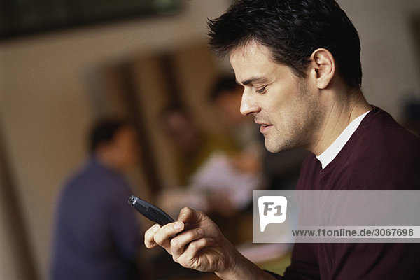 Man text messaging with cell phone