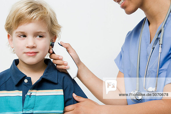 Boy with thermometer in ear