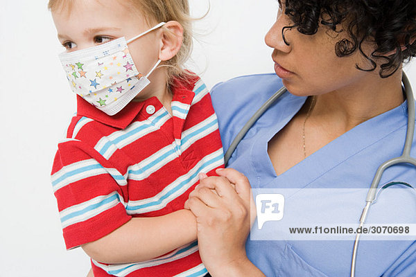 Nurse and little boy wearing mask