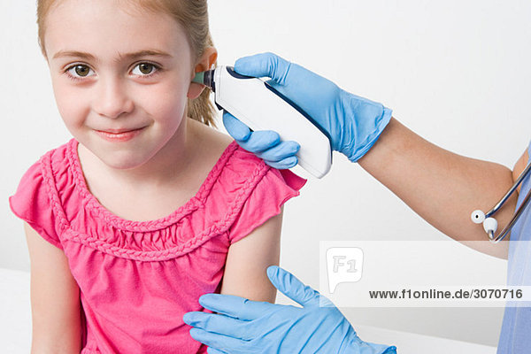 Girl with thermometer in ear