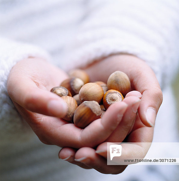 A woman holding hazel nuts Sweden.