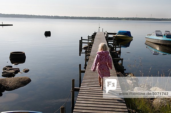 A blond girl on a jetty Sweden.