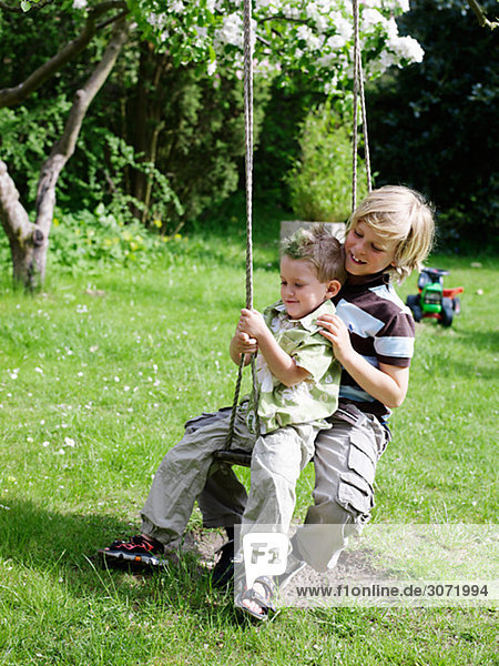 Brothers playing in a garden Skane Sweden.