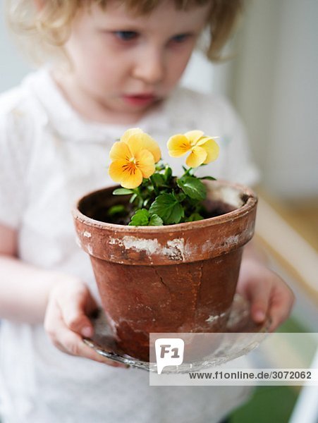 A girl potting plants Sweden.