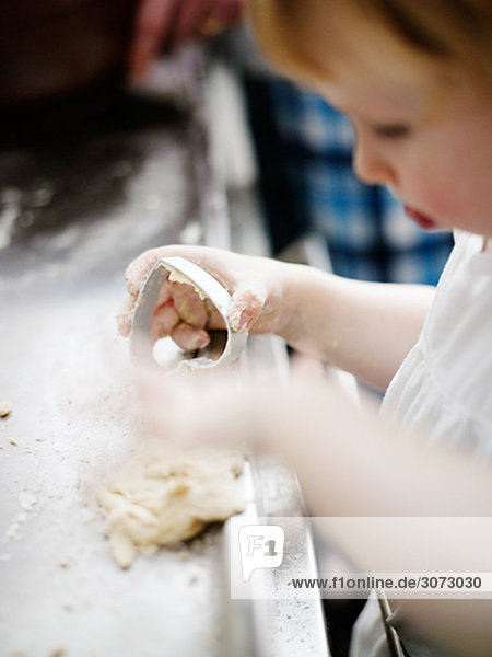 A little girl baking gingerbread Sweden