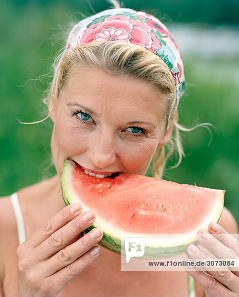 A woman eating a watermelon Sweden.