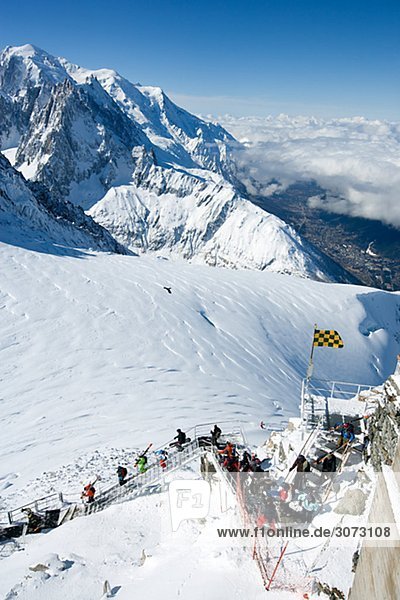 Skiers going down the steps Grand montets Chamonix France.