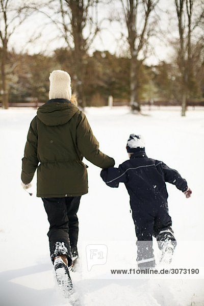 Mother and boy playing in the snow Gotland Sweden.