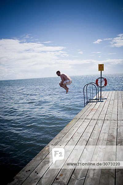 A man going for a swim Skane Sweden.