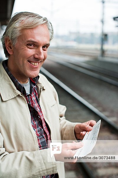 A man at a platform of a railway station Sweden.