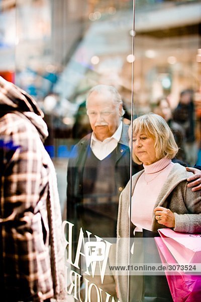 A senior couple window-shopping Stockholm Sweden.