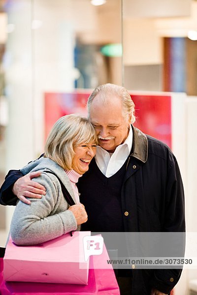Senior couple carrying shopping bags Stockholm Sweden.