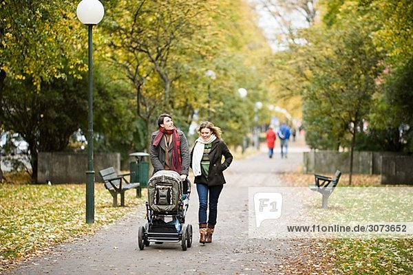 A couple taking a walk with their son Sweden.