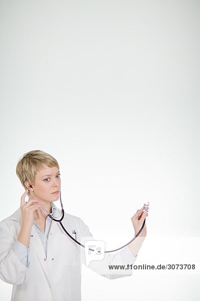A female doctor listening into a stethoscope Sweden.