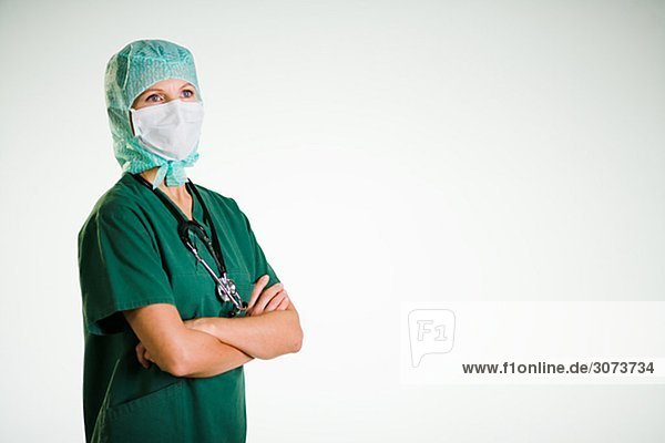 A doctor wearing a green uniform.
