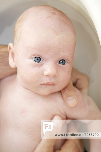 Mann badet ein Baby  Close-up