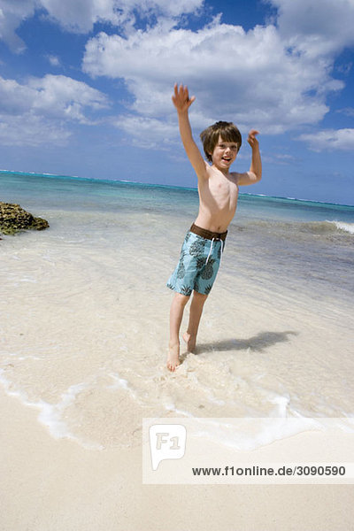 A young boy jumping on the beach  Cable Beach  Nassau  Bahamas  Caribbean