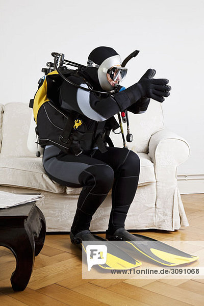 A scuba diver diving off a couch in a living room