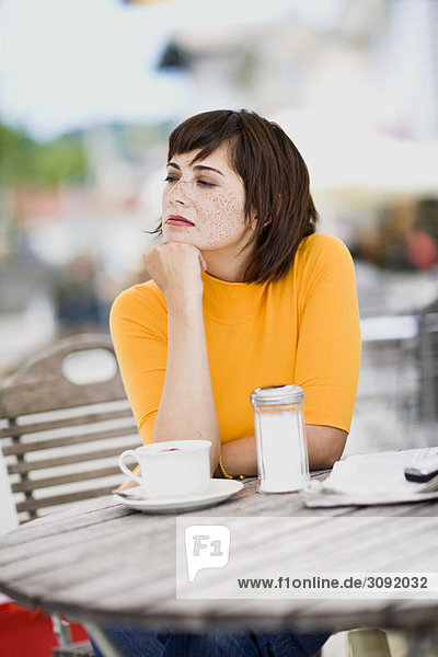 woman waiting in a street cafe