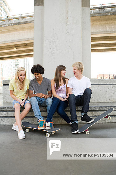 Teenage friends with skateboards