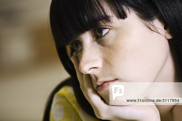 Young woman contemplatively looking away